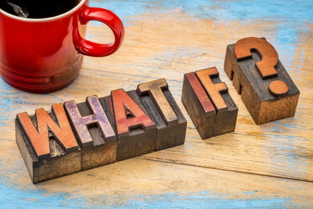 Red coffee mug beside vintage wooden letter blocks spelling 'NEW YEAR' on a distressed blue wooden surface.